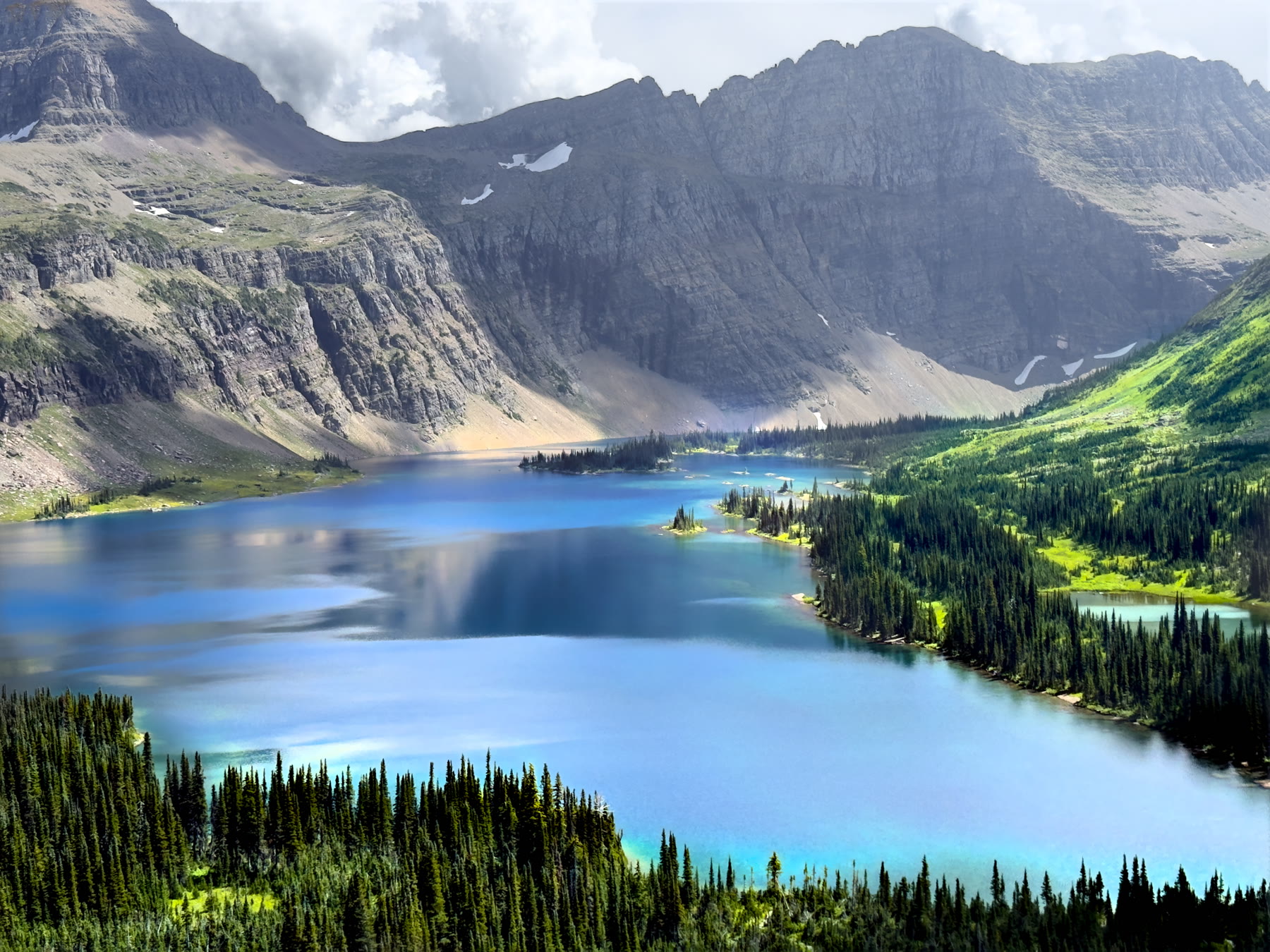 Alpine lake surrounded by mountains and evergreens